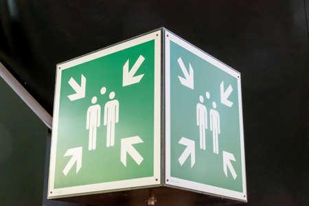KRAUSNICK, GERMANY - Jan 11, 2020: green rectangular sign for a collection point in case of an emergency in case of fire or disaster, placed in the height with white pictogramsのeditorial素材
