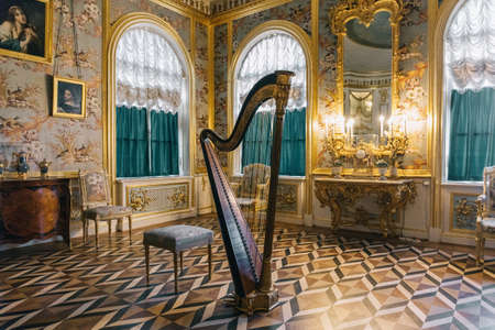 The hall in Peterhof Palace with a harp in the middle of the room in Saint Petersburg, Russia