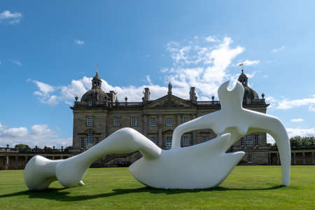 FAKENHAM, UNITED KINGDOM - Aug 07, 2019: The Henry Moore sculpture Large Reclining Figure outside Houghton Hall in Norfolk, Englandのeditorial素材