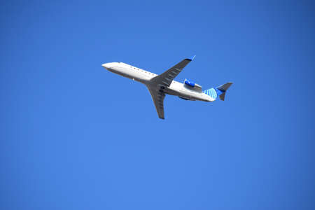 FRESNO, UNITED STATES - Dec 30, 2020: A photo of United Airlines in flight against a bright blue sky...