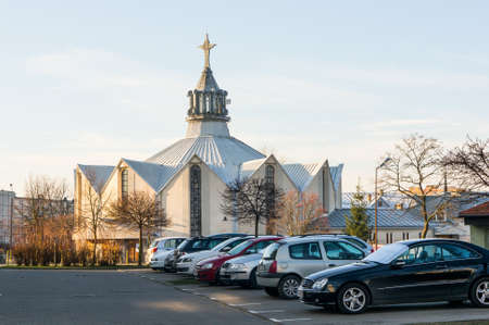 POZNAN, POLAND - Dec 31, 2015: Parked cars in front of the Najswietszej Bogarodzicy Maryi church in the Stare Zegrze areaのeditorial素材