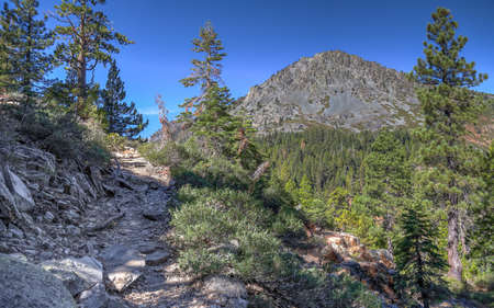 SOUTH LAKE TAHOE, CALIFORNIA, UNITED STATES - Oct 14, 2020: A hiking trail ascends from the South Lake Tahoe community of Fallen Leaf Lake with Mt Tallac dominating the skyline.のeditorial素材