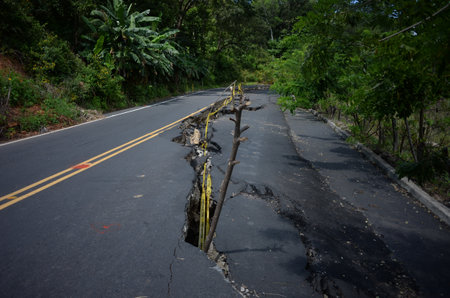 Earthquake-damaged street with a creepy crack in the middleの写真素材