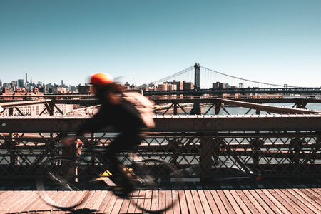 Cyclist in Brooklyn bridge with NewYork as backgroundの写真素材