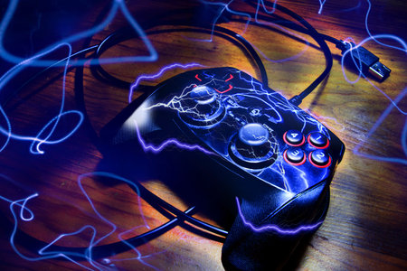 black gamepad with lightning and electric effect around, on a dark background, Videogame controller