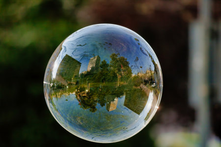A soft focus of a bubble with reflection of city buildings and trees on it