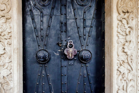 An old ornate church door with a lockの写真素材