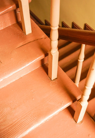 A vertical shot of a wooden stairs hall inside a building