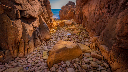 A beautiful panoramic shot of cliffs and rocks with a sea on the backgroundの写真素材