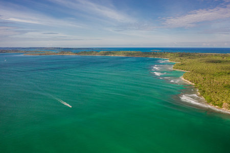 The mesmerizing view of the coastline with white sand and turquoise clear water in Indonesiaの写真素材