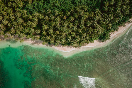 The mesmerizing view of the coastline with white sand and turquoise clear water in Indonesiaの写真素材