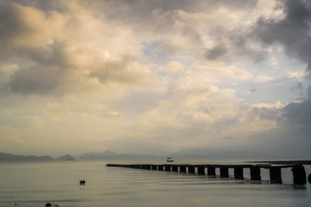 A broken pier in the lake during the sunrise in Hong Kongの写真素材