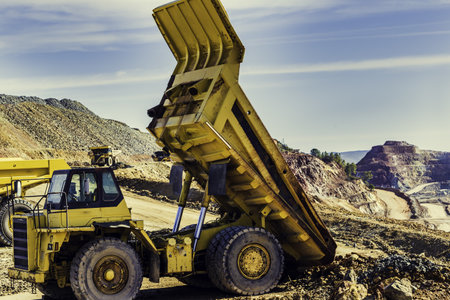 The yellow mining trucks at the Riotinto Mines under the sunlight at daytime in Huelva in Spain