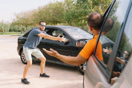 A selective focus shot of a person arguing with the driver at a car crashの写真素材