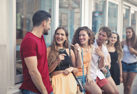 A group of young people smiling while standing in the streetの写真素材
