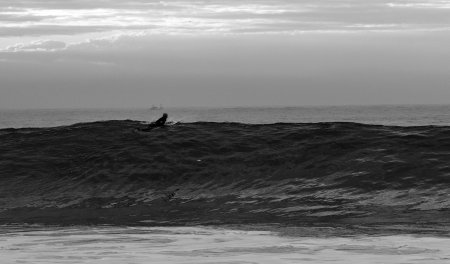 A surfer on the waves of the ocean in the Copacabana beachの写真素材