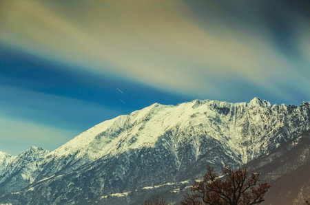 A mesmerizing picture of a snowy mountain under the beautiful sky at daytime