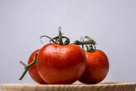 red tomatoes on a wooden boardの写真素材