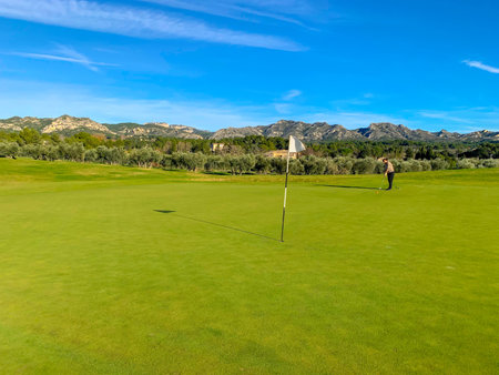 A wide angle shot of a person on a golf fieldの写真素材