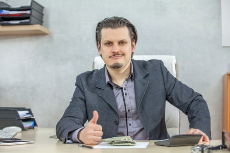 A young businessman working from his office - the concept of confidence