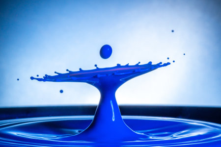 A closeup of a cool blue water splash against a blurred background - great for wallpapersの写真素材
