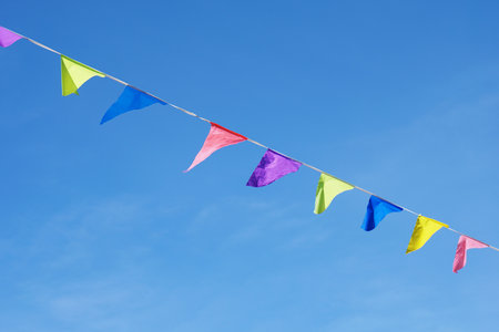 The colorful flags over a blue clear sky