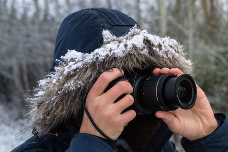 A person taking photos with a professional cameraの写真素材
