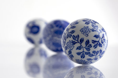 A closeup of a blue & white porcelain decor balls against a white backgroundの写真素材