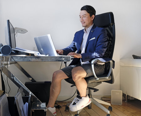 Working from home: man wearing a suit for the video call while also wearing sweatpantsの写真素材