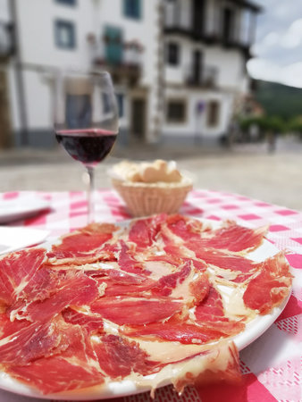A closeup shot of prosciutto and red wine in Italyの写真素材