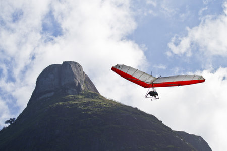 An amazing shot of human flying on a hang gliderの写真素材