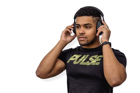 A male athlete putting on his headphones before the workout