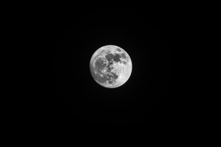 A low angle shot of the breathtaking full moon captured in the night skyの写真素材