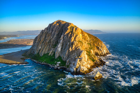 An aerial shot of the Morro Rock in California at middayの写真素材