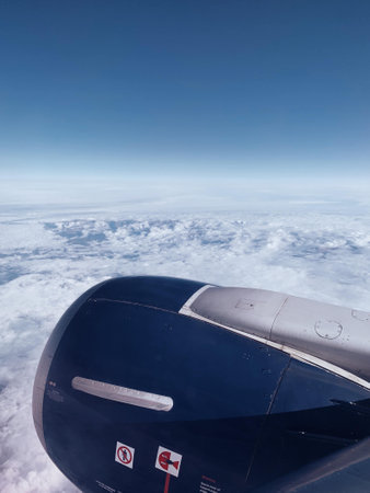 A vertical closeup shot of a propeller of an airplane above the clouds