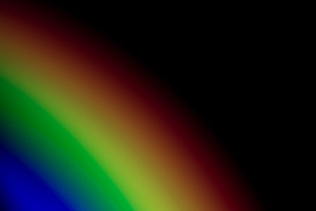 A cool wallpaper with blurred rainbow lights isolated on a black background