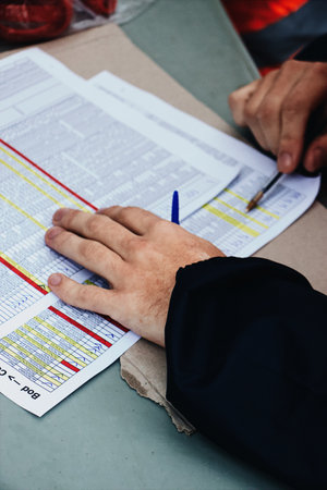 The hands of a man while working on the important documents
