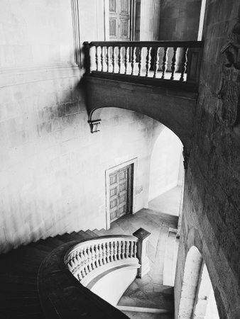 A greyscale shot of the stairs and halls of the Alhambra Palace in Granada, Spainの写真素材