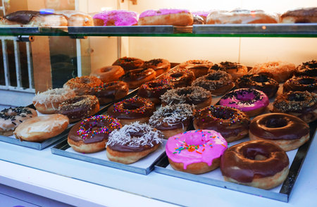 A closeup shot of tasty doughnuts on the bakery shelvesの写真素材