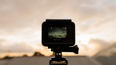A selective focus shot of a camera capturing the beautiful clouds on a sunny dayの写真素材