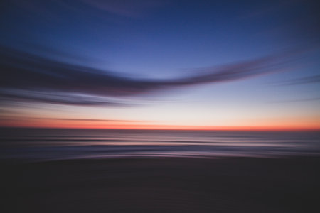 A breathtaking shot of the reflection of a colorful sunset with long exposure effectの写真素材