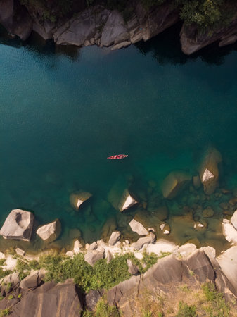 An aerial shot of a boat in the Spiti river, Indiaの写真素材