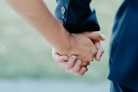 A shallow focus shot of a  romantic couple holding handsの写真素材