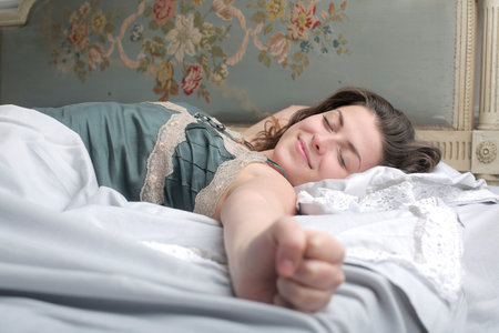 A young female sleeping peacefully in the bed in the morning