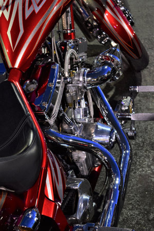 A vertical closeup shot of the details of a modern red and blue motorcycle