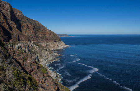 The Table Mountain National Park surrounded by the sea under the sunlight and a blue sky at daytime...