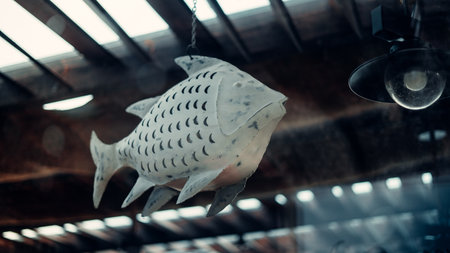 A low angle closeup shot of a white fish figure hanging from the ceilingの写真素材