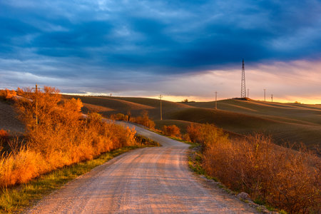 A beautiful view of a road in the Tuscan countryside during the autumn seasonの写真素材