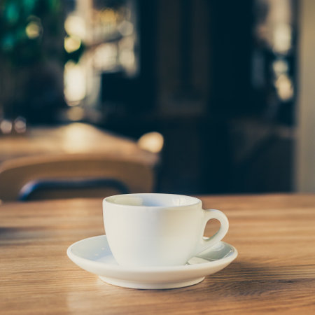 A closeup shot of a white cup of coffee on the table