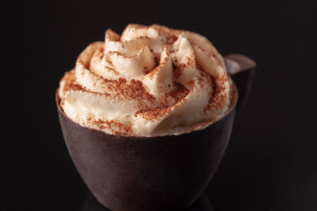 A cup of coffee on a table with creamの写真素材